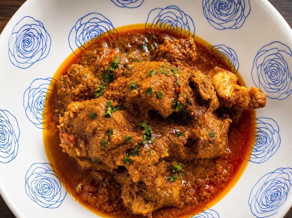 Dahi-marinated chicken curry in a whole-spice gravy