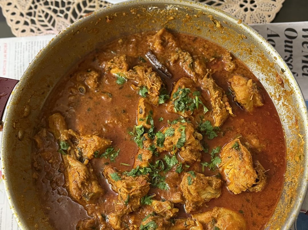 Chicken in a tomato gravy with coriander scattered on top