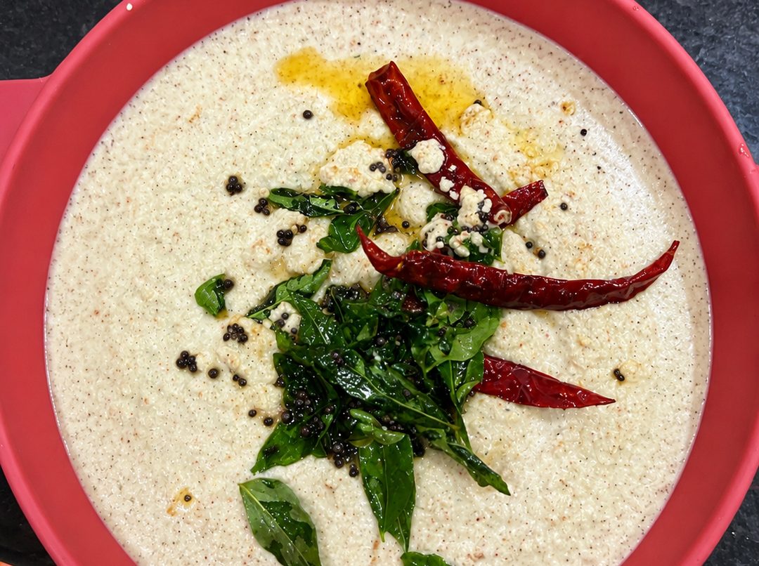 Set curd with a tempering of curry leaves and dried red chilli poured over