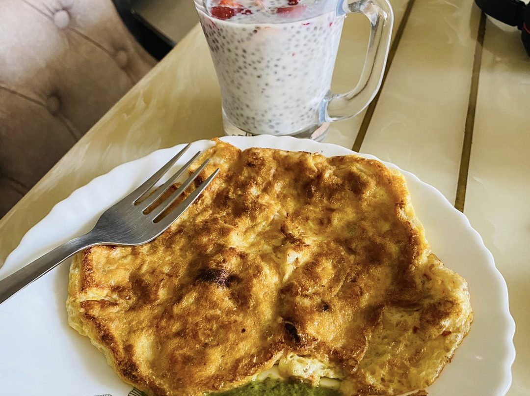 A thin egg chilla folded on a plate, cooked in ghee