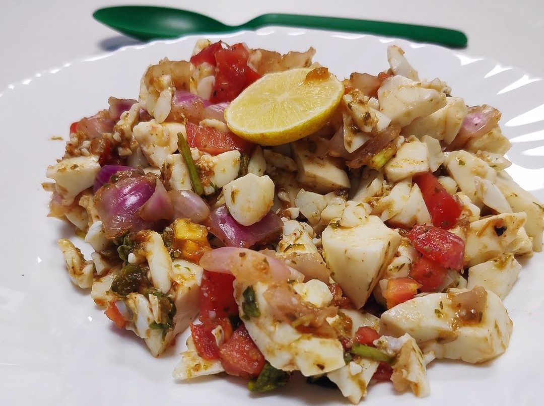 Chopped kachumber of onion, tomato and cucumber with chopped boiled egg and lemon